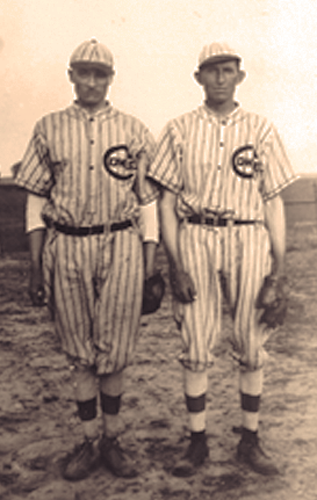 George on right and another man in baseball uniform with gloves.